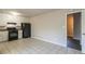 View of kitchen with white cabinets, black appliances, and tile floor at 8652 Embrey Dr, Jonesboro, GA 30236