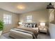 Virtually staged main bedroom with large bed and neutral decor at 8652 Embrey Dr, Jonesboro, GA 30236