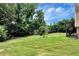Large backyard with lush green grass and trees at 1426 Greenridge Trl, Lithonia, GA 30058