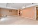 Spacious basement media room with carpeted floor at 1426 Greenridge Trl, Lithonia, GA 30058