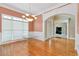 Elegant dining room with hardwood floors, wainscoting, and a view into the entryway at 1426 Greenridge Trl, Lithonia, GA 30058
