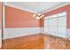 Formal dining room features hardwood floors, wainscoting, and a chandelier at 1426 Greenridge Trl, Lithonia, GA 30058