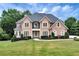 Two-story house with a large front yard and a three-car garage at 1426 Greenridge Trl, Lithonia, GA 30058
