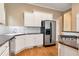 Modern kitchen with white cabinets, granite countertops, and stainless steel appliances at 1426 Greenridge Trl, Lithonia, GA 30058