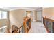 Upstairs hallway with wood railing, carpet, and window at 1426 Greenridge Trl, Lithonia, GA 30058