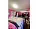 Spacious bedroom with pink walls, large bed, and ample closet space at 985 Farrington Se Pl, Atlanta, GA 30315