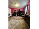 Main bedroom with pink walls, large bed, and home gym area at 985 Farrington Se Pl, Atlanta, GA 30315