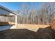 Spacious backyard with wooden privacy fence and wooded backdrop at 1076 Allspice Way, Lawrenceville, GA 30045
