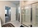 Main bathroom with marble floor, shower, and access to bedroom at 1076 Allspice Way, Lawrenceville, GA 30045
