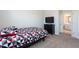 Guest bedroom with TV, dresser and carpet at 1076 Allspice Way, Lawrenceville, GA 30045