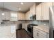 Modern kitchen with stainless steel appliances and granite countertops at 1076 Allspice Way, Lawrenceville, GA 30045