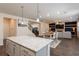 Open kitchen with granite island, stainless steel appliances, and dark hardwood floors at 1076 Allspice Way, Lawrenceville, GA 30045