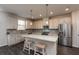 Kitchen boasts granite countertops and white cabinets at 1076 Allspice Way, Lawrenceville, GA 30045