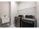 Laundry room with LG washer and dryer, utility sink, and overhead shelving at 1076 Allspice Way, Lawrenceville, GA 30045