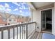 Cozy balcony features a wooden floor, wood railing, a view of neighboring houses, and a doorway to the Primary bedroom at 7174 Fringe Flower Dr # 21, Austell, GA 30168