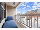 Cozy balcony features a wooden floor, wood railing, a view of neighboring houses, and a comfortable blue chaise lounge at 7174 Fringe Flower Dr # 21, Austell, GA 30168
