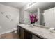 Bright bathroom featuring a long single sink vanity with granite countertop, a neutral color palette, and a bath tub at 7174 Fringe Flower Dr # 21, Austell, GA 30168