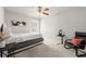 Cozy bedroom featuring soft carpet, neutral walls, and a modern ceiling fan, creating a serene and restful space at 7174 Fringe Flower Dr # 21, Austell, GA 30168