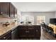 Kitchen island with granite countertops, stylish cabinetry, and view into the living room at 7174 Fringe Flower Dr # 21, Austell, GA 30168