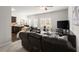 Comfortable living room with dark leather furniture, open floorplan and lots of natural light at 7174 Fringe Flower Dr # 21, Austell, GA 30168