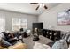 Bright living room featuring leather furniture, a ceiling fan, and decorative artwork at 7174 Fringe Flower Dr # 21, Austell, GA 30168