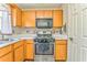 Bright kitchen with wood cabinets, stainless steel appliances, and white countertops at 108 Ivy Trace Ln, Dallas, GA 30157