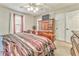 Spacious main bedroom with large wood furniture and ceiling fan at 108 Ivy Trace Ln, Dallas, GA 30157