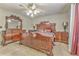 Spacious main bedroom with large wood furniture and ceiling fan at 108 Ivy Trace Ln, Dallas, GA 30157