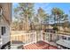 View from the back deck showing the backyard, storage building and surrounding trees at 118 Gilberts Way, Temple, GA 30179