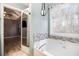 Stylish bathroom featuring a bathtub, large window and a view to the bedroom at 118 Gilberts Way, Temple, GA 30179