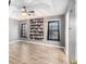 A modern primary bedroom features a tray ceiling with fan and hardwood floors at 118 Gilberts Way, Temple, GA 30179