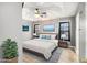A comfortable bedroom with a ceiling fan, artwork, and blue accents at 118 Gilberts Way, Temple, GA 30179