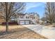 Charming two-story home with attached two-car garage and inviting elevated porch and a long concrete driveway at 118 Gilberts Way, Temple, GA 30179