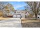 Charming two-story home with attached two-car garage and inviting elevated porch and a long concrete driveway at 118 Gilberts Way, Temple, GA 30179