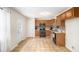 Eat-in kitchen with wood cabinets, stainless appliances, tile backsplash, tile flooring, and backyard access at 118 Gilberts Way, Temple, GA 30179