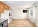 Kitchen with wood cabinets, stainless appliances, tile backsplash, tile flooring, and a view of the dining room at 118 Gilberts Way, Temple, GA 30179