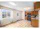 Eat-in kitchen with wood cabinets, stainless appliances, tile backsplash, tile flooring, and backyard access at 118 Gilberts Way, Temple, GA 30179