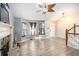 Inviting living room featuring wood floors, vaulted ceiling with fan, stone fireplace and staircase at 118 Gilberts Way, Temple, GA 30179