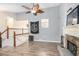 Inviting living room featuring wood floors, vaulted ceiling with fan, stone fireplace and staircase at 118 Gilberts Way, Temple, GA 30179