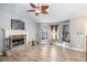 Inviting living room featuring wood floors, vaulted ceiling with fan, stone fireplace and staircase at 118 Gilberts Way, Temple, GA 30179