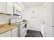 The kitchen includes white cabinets, white appliances, and tile floors at 1525 Terrell Mill Se Pl # A, Marietta, GA 30067