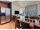 Bright dining area with wood table, hardwood floors, and kitchen access at 943 Peachtree Ne St # 902, Atlanta, GA 30309