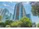 Modern high-rise building with glass facade and landscaped grounds at 943 Peachtree Ne St # 902, Atlanta, GA 30309
