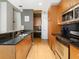 Modern kitchen with wood cabinets, granite countertops, and breakfast bar at 943 Peachtree Ne St # 902, Atlanta, GA 30309