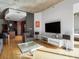 Open living area with hardwood floors, large TV, and comfortable seating at 943 Peachtree Ne St # 902, Atlanta, GA 30309