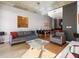 Bright living room features hardwood floors, gray sofa, and a spacious layout at 943 Peachtree Ne St # 902, Atlanta, GA 30309