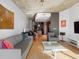 Sunlit living room with hardwood floors, gray sofa and dining area at 943 Peachtree Ne St # 902, Atlanta, GA 30309