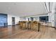 Community lounge with a long table, bar stools, and hardwood floors at 943 Peachtree Ne St # 902, Atlanta, GA 30309