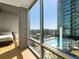 Bedroom with floor to ceiling windows and city views at 943 Peachtree Ne St # 902, Atlanta, GA 30309