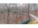 House nestled in a wooded lot with a long driveway leading to the home at 9545 Grande Dr, Winston, GA 30187